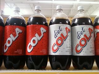 I was visiting my ex-Walmart store in January with Katie while I was in town for the wedding, and we happened upon this. What you are looking at is a row of soda bottles, but notice the brand. Specifically, there isn't one. This isn't Walmart's "Sam's Choice" soda, which is the store-brand soda. This is truly generic soda. What's it called? "Cola". What's it taste like? You probably don't want to know...