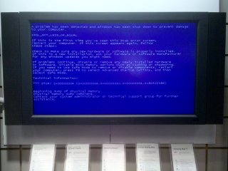 When I was stopping by the Verizon store in College Park for some service on my Droid, I noticed this screen, normally used to display information about various Verizon products, was this time showing information of a decidedly different nature. Specifically, we all learned that this display was running Windows, as this was a Blue Screen of Death...