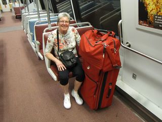 And here we go! Mom poses with her luggage on Alstom 6083 on the Red Line, heading to Union Station.