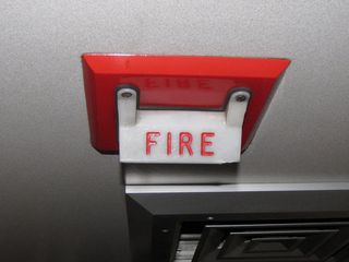 This is a first for me. We were on a Superliner II transition sleeper on the way out to Chicago, and I was surprised to see a fire alarm strobe on board. There were two signals near to each other in the center of the car. One said "FIRE", and the other said "Nofity crew member when flashing".