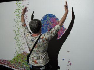 In one part of the museum, we found projectors where you could interact with what was being projected. Here, Mom holds up a stack of something. Then when you moved, the stuff she was "holding" fell to the ground. I have no idea how it worked, but it was fun to watch.