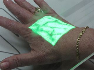 Here, Mom puts her hand under a light that reveals the blood vessels in her hand.