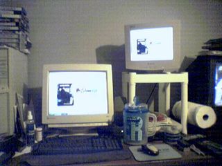 This is how my desk looked for most of 2005. I had two monitors, with one up and one down. Near the end of the year, I got a new flat panel monitor, and the lower monitor became the upper monitor.