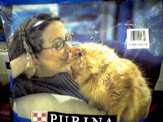 Looking at this photo on the Purina Cat Chow bag, it makes one wonder. It makes me wonder if she's really a cat person, or if she actually hates cats in real life...