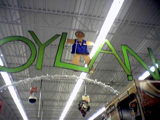 At the Wal-Mart in Warrenton on December 14, Gingy hangs from the ceiling, wearing an authentic Wal-Mart vest and name badge.