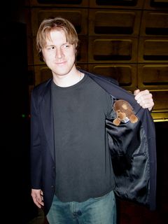 At the U Street-Cardozo station, Chris poses with Sis's stuffed monkey like a shady street salesman, commenting, "Hey, you want to buy a monkey?"