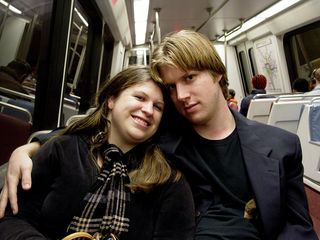 On the Metro, Sis flashes a smile for the camera, while Chris stares directly into the lens.