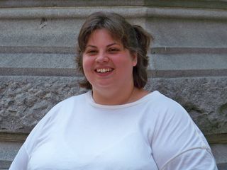 Katie smiles for a photo in front of the Old Post Office.