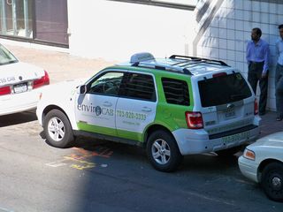 In Rosslyn in September, I spotted a taxicab operated by EnviroCab. Apparently this cab company promotes itself as being "green" by using hybrid vehicles, but is an SUV, hybrid or not, really all that "green"?