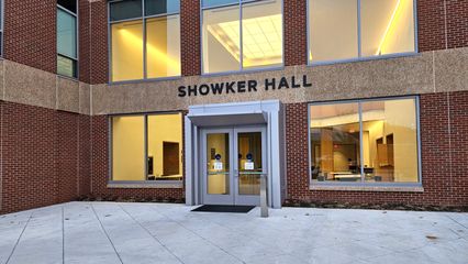 At the entrance itself, the greenhouse-style vestibule had been replaced by a smaller, more modern vestibule.  The colonnade is gone.  "Showker Hall" lettering is now in place over the entrance.
