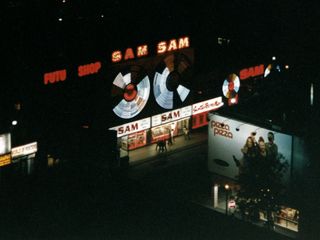 I took many pictures of the night skyline, but none came out, except for this one at left, of Sam the Record Man. The lights on these two circles were not partly burned out, but rather, the lights flashed to simulate spinning.