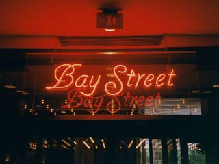 These neon signs were above each of the hotel's main entrances, opening out onto Bay Street, Elm Street, Gerrard Street, and Yonge Street. It was the Yonge Street entrance where Pete took Sarah down the stairs.