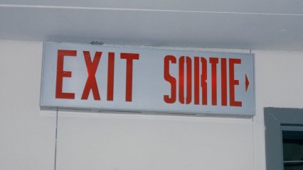 Two things you always take for granted - exit signs and fire alarms. In a country with two official languages (English and French), everything was bilingual. Thus "SORTIE" is added to an exit sign, and "FEU" is added to a fire alarm pull station.