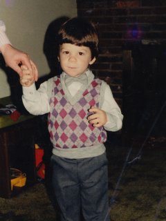 This is me prior to an unsuccessful attempt at getting some professional portraits done. As I understand it, my parents dressed me up as you see, and then we went to an Olan Mills studio. Then at Olan Mills, they kept us waiting for so long that it had become ridiculous, and I, being my usual energetic self, was no longer looking my best on account all of the above. We ended up leaving, and my parents still won't patronize any Olan Mills location to this day on account of this incident.