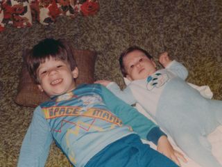 Sis and I laying on the floor in the family room in Rogers.