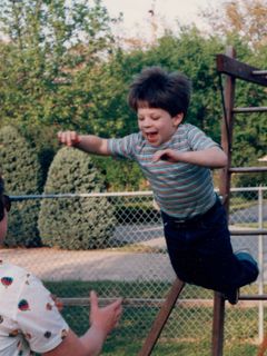 Jumping off our old swingset in Rogers, into Mom's waiting arms.