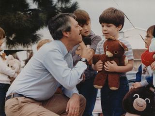 Speaking about Chris the bear with the then-mayor of Rogers, John Sampier, at the Teddy Bear Parade.