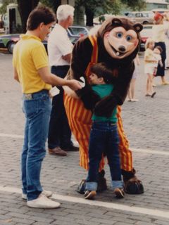 At another event in downtown Rogers, I'm getting a hug from Billy Bob (of Showbiz Pizza fame), while a man tries to hand me a flier of some sort. I love my expression here, kind of saying, do you mind?