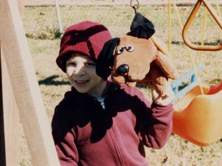 Posing outside with a stuffed Pound Puppy.