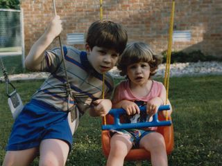 Sis and I pose for the camera on the old swingset in Rogers.