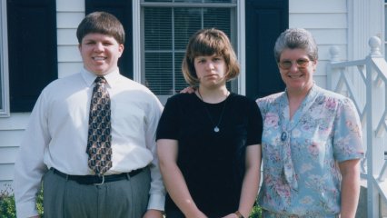 Just before leaving for my high school graduation, Mom, Sis, and I pose for a photo. Sis's expression is priceless, as if to say, "get me out of here."