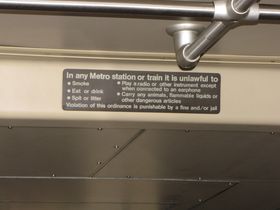Rules sign: The rules sign on the 1000-Series is centered near the ceiling at both ends of the car.