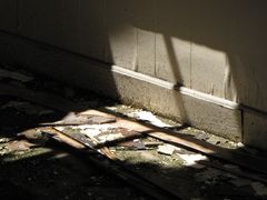 Patch of light on the floor of one of the abandoned motel rooms, coming through a large hole in the roof.