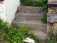 Broken glass litters the steps up to the guest rooms.