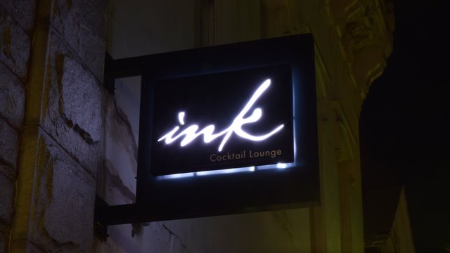 Street-facing sign for the Ink Cocktail Lounge.