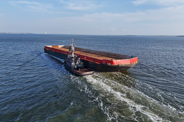 The tugboat Helen pushes the barge CMT Y Not 8 up the Cooper River.