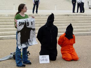 Some participants had signs near them, such as "Abu Ghraib" and "Guantanamo Bay".