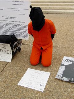 One participant placed a sign on the sidewalk in front of them, saying, "Certain acts may be cruel, inhuman, degrading... our country has got to be BETTER than this!"