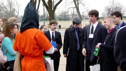 Before beginning a short march around to the Capitol's west side, bystanders engaged a few participants in a question-and-answer session.