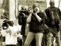 A woman photographs the events in Crystal City