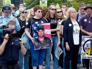 One woman near the front of the group held up a large photo of a soldier killed in Iraq.