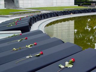 Behind the stage, along the reflecting pool, lay roughly 100 replica coffins, representing some of the dead in Iraq. Each one had a rose on top of it. These coffins would be carried by participants to the Ellipse.