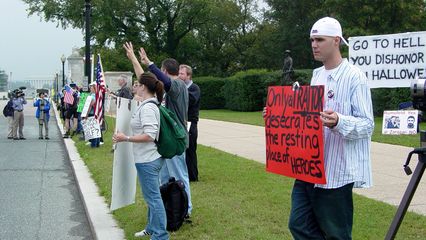 The counter-protest group came off as being small but dedicated. The message on the orange sign, saying, "Only a TRAITOR desecrates the resting place of HEROES," managed to raise a few eyebrows with the main protest group. How is a peace march desecrating a cemetery?