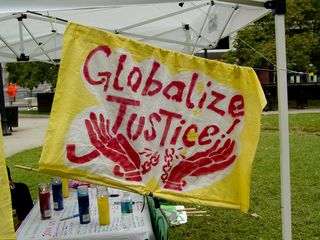 Around the tent, cloth banners were hung, painted with images stating viewpoints on the activities of the World Bank and the IMF.
