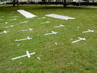 Additionally, small wooden crosses were placed all over the ground, each with the name of a third world country, and the amount of their debt.
