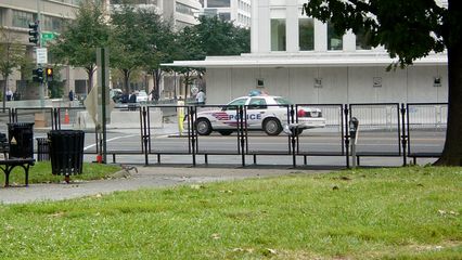 The area around the World Bank was barricaded off, creating a secure zone going a number of blocks in all directions. Murrow Park was about the only way that anyone could actually see the World Bank building, and the park itself was barricaded on three sides. On one side, the barricades extended as far away as Farragut Square, where a vehicle access gate was set up.