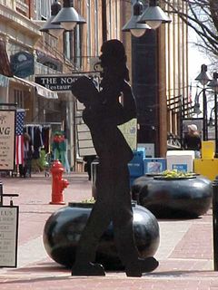 Throughout downtown, there's a number of black-painted wooden people in various poses. This one involves a man holding up a bust of what appears to be a man. Other ones involve a mother being pulled along by her kid, a woman carrying shopping bags, a man walking, and others.