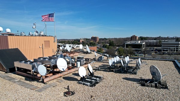 The roof of 100 Lakeforest Boulevard in Gaithersburg, Maryland.  I was surprised that all of these satellite dishes were being held down by cinderblocks.