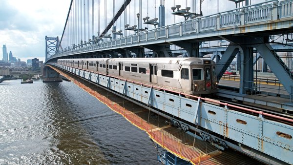 A PATCO train crosses the Delaware River from Philadelphia to New Jersey via the Benjamin Franklin Bridge.