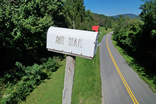Mailbox marked "AIR MAIL" mounted on top of a very tall pole along Love Road in Augusta County, Virginia.