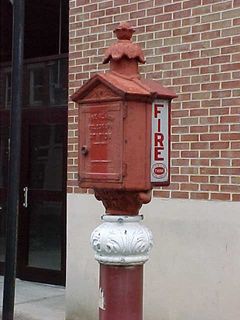 The fire box, when you look at it closely, is actually two fire boxes put together. The side seen at left is the newer side, in one of Gamewell's more recent styles, whereas the side seen at right is an older style. It is believed that the older side was once a complete fire box, and for some reason or other, the inside was removed and the newer fire box was added onto one side of the old box.
