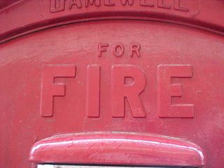 In case of fire, pull down the cover, and pull down the hook inside. These shots are the first to give evidence to the fire box having been repainted. On the standard-issue boxes, the "FOR FIRE" is painted in white, and then the "Open then pull down hook" is painted in red.