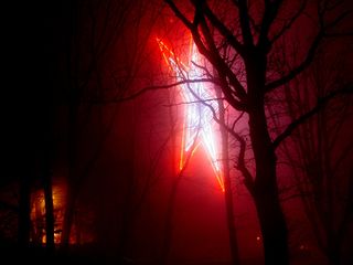 As viewed from the side and taken at longer exposures, the fog, along with the glow of the outer red neon, seems to create the illusion of the outermost ring being a ring of flame.