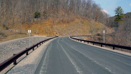 On top of Gathright Dam, a road runs across. No parking is allowed on the dam. From this vantage point, Lake Moomaw is on the left, and the Jackson River is on the right.