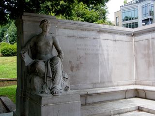 Next to the female figure at left, the inscribed text provides the dates of his presidency in Roman numerals, while the inscribed text next to the male figure at right reads, "The incorruptible statesman whose walk was upon the mountain ranges of the law."