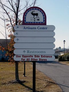 These signs helped visitors navigate the Outlet Village, by indicating which stores were right around the corner. In the facility's heyday, all of these signs were six-tiered. Over the years, some signs were shortened. This was also the only place where "labelscar" (markings left over after signs were removed) could be found, indicating former tenants.